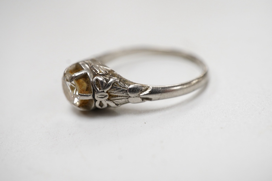 A white metal and claw set solitaire diamond ring, the stone weighing approx. 0.25ct, size N.